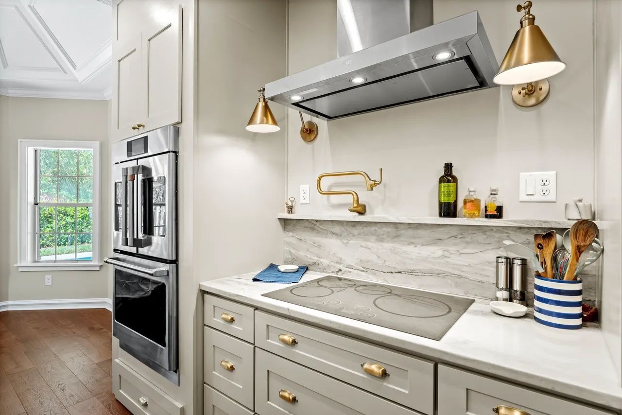 a kitchen with a stove top oven and a bottle of olive oil