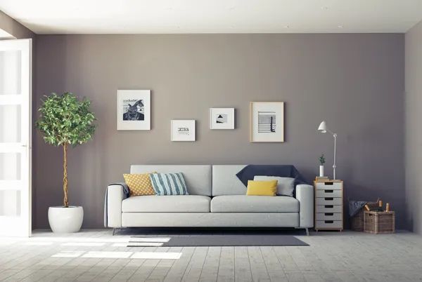 a living room with a white couch and a potted plant