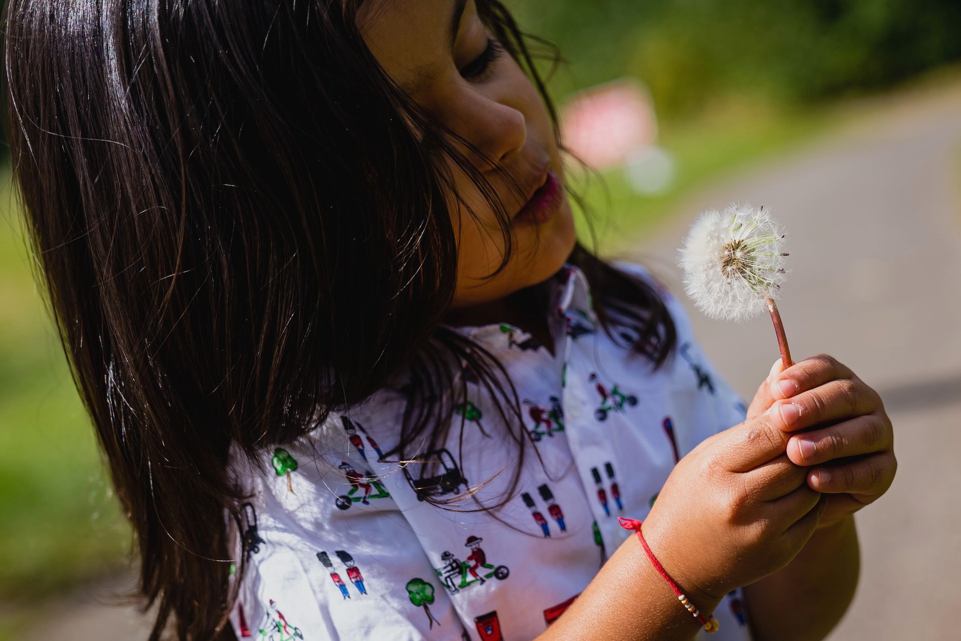 boy blowing a dandelion