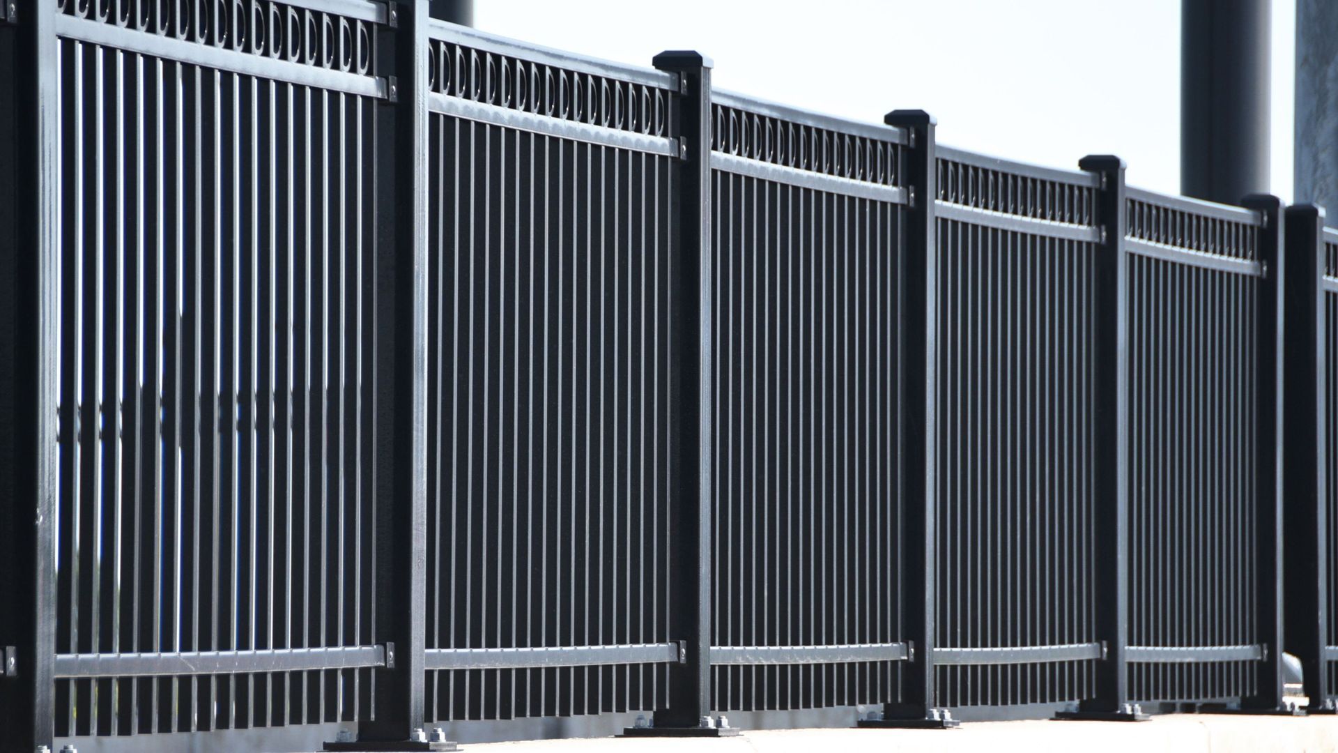 A close up of a metal fence with a white background
