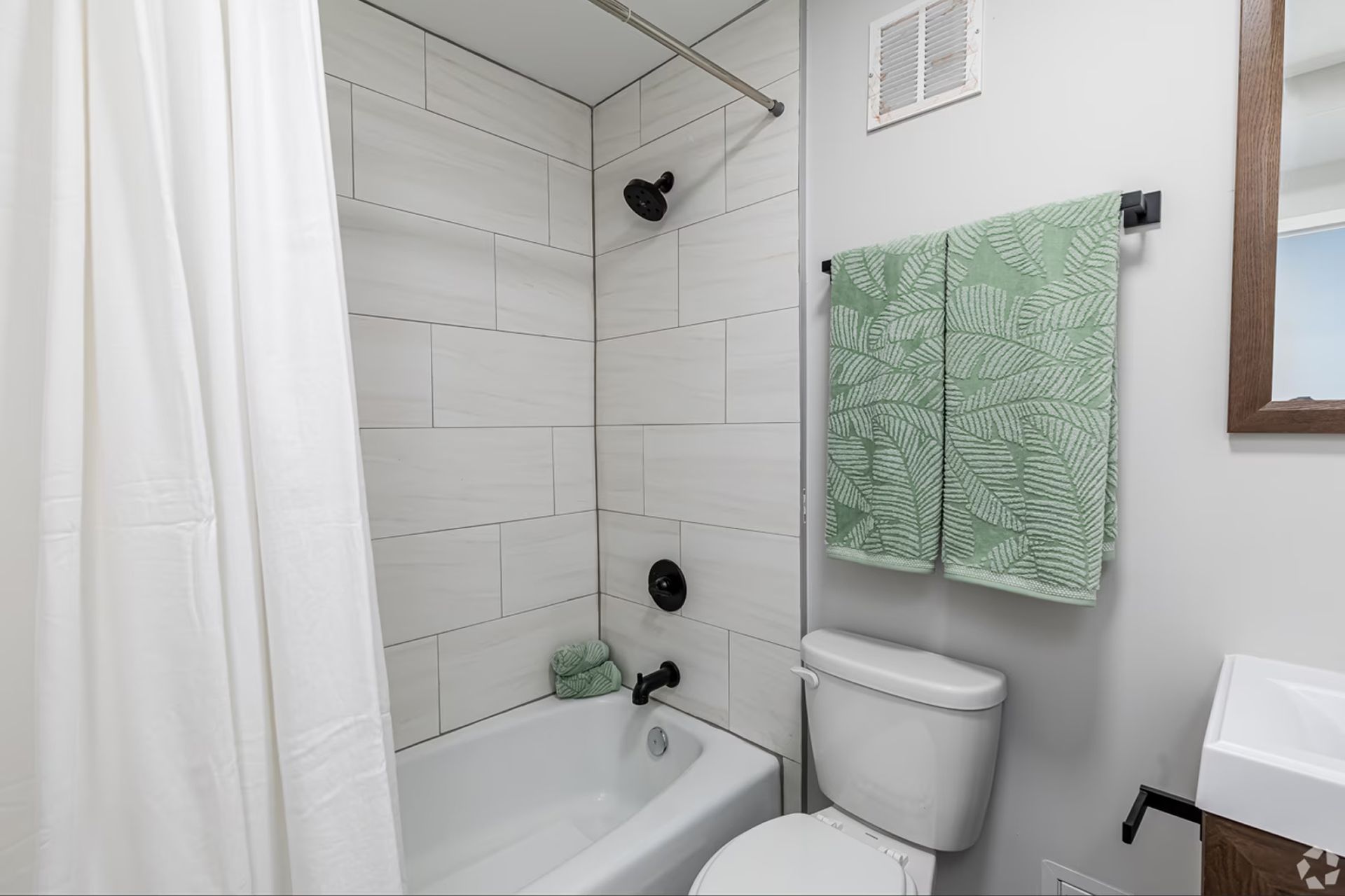 Modern apartment bathroom with tub and shower at The Millennium Hartford