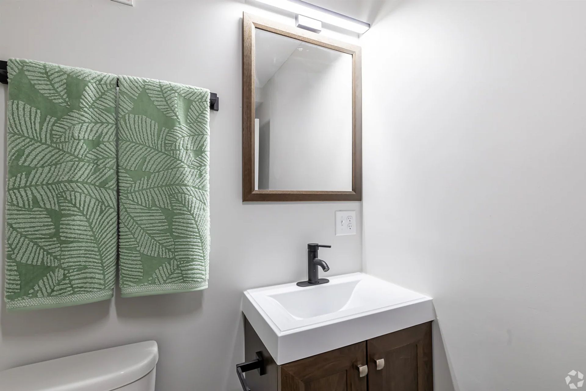 Contemporary apartment bathroom vanity with mirror and sink at The Millennium