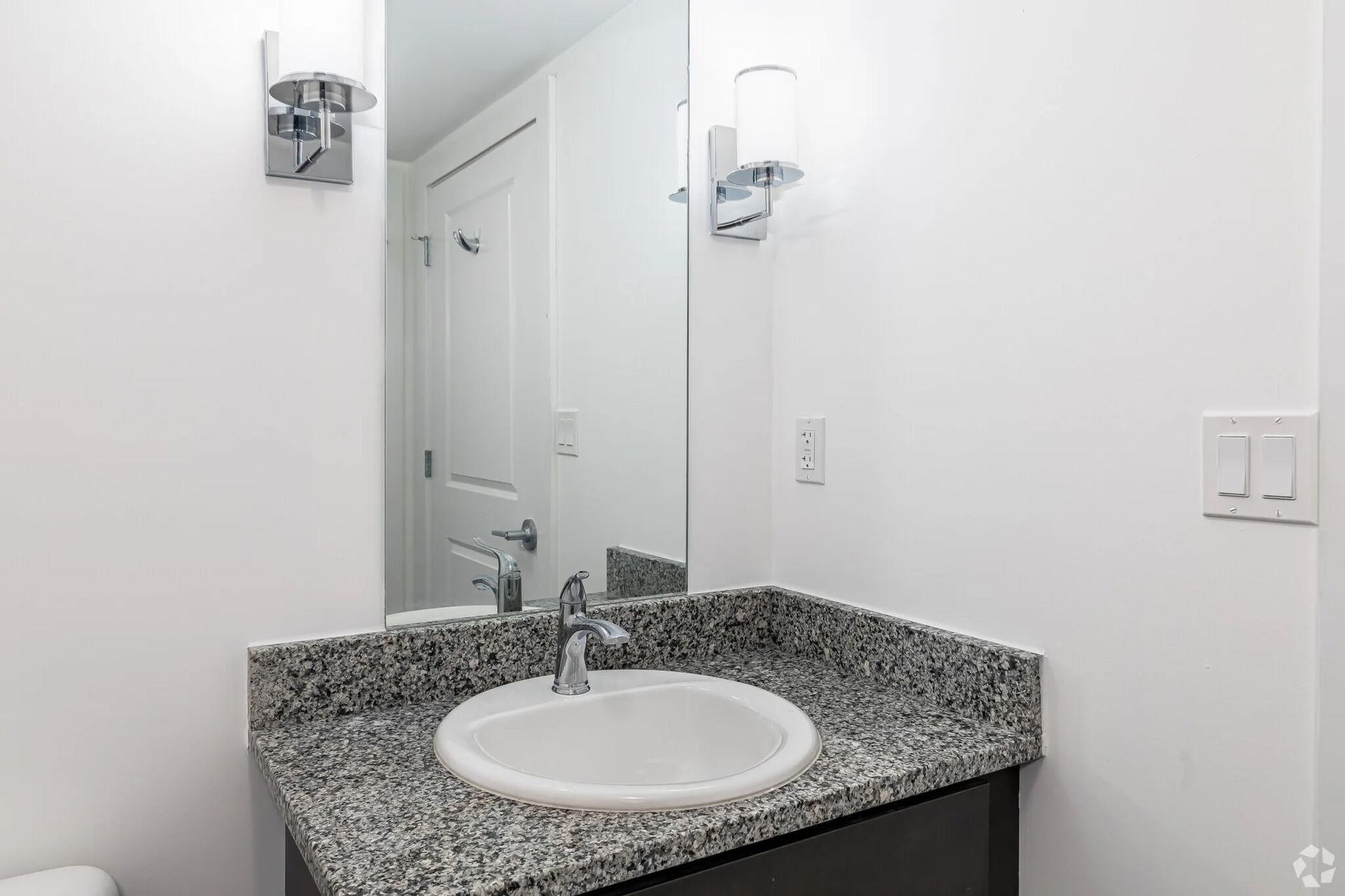 Apartment bathroom with granite countertop and sink at The Millennium Hartford