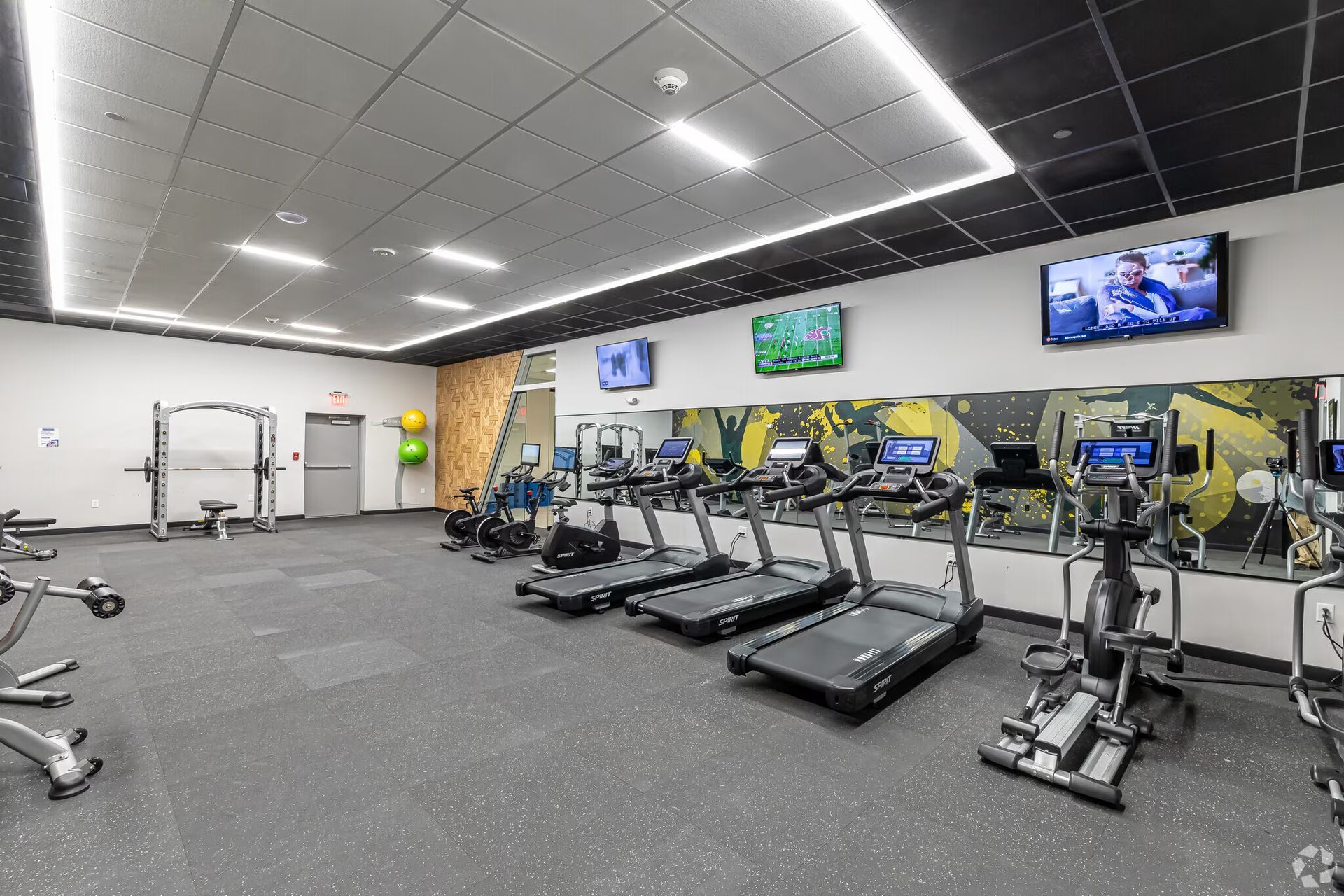 Resident fitness center with treadmills and cardio equipment at The Millennium