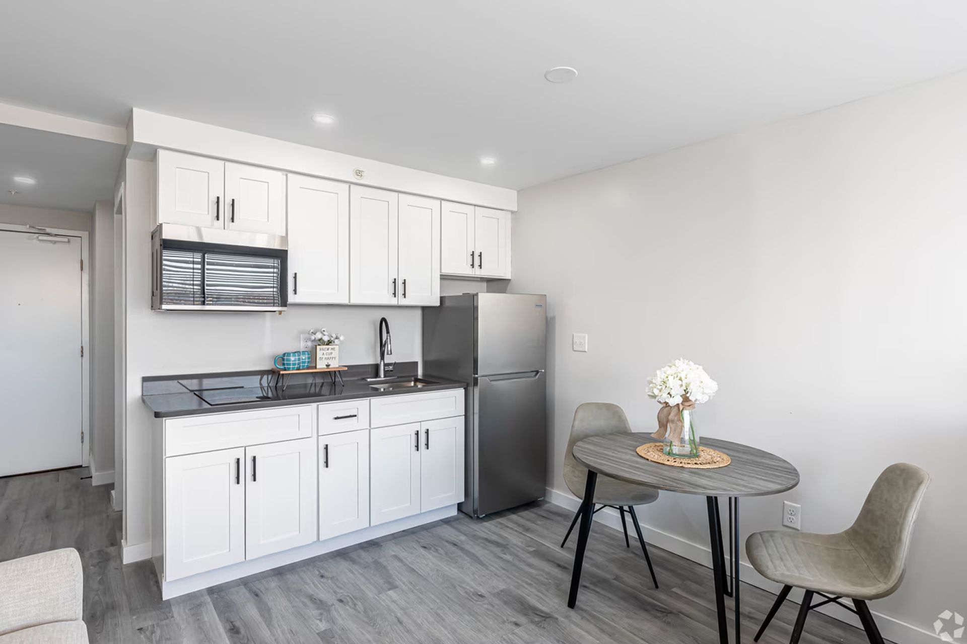 Modern white kitchen inside a studio apartment at The Millennium Hartford