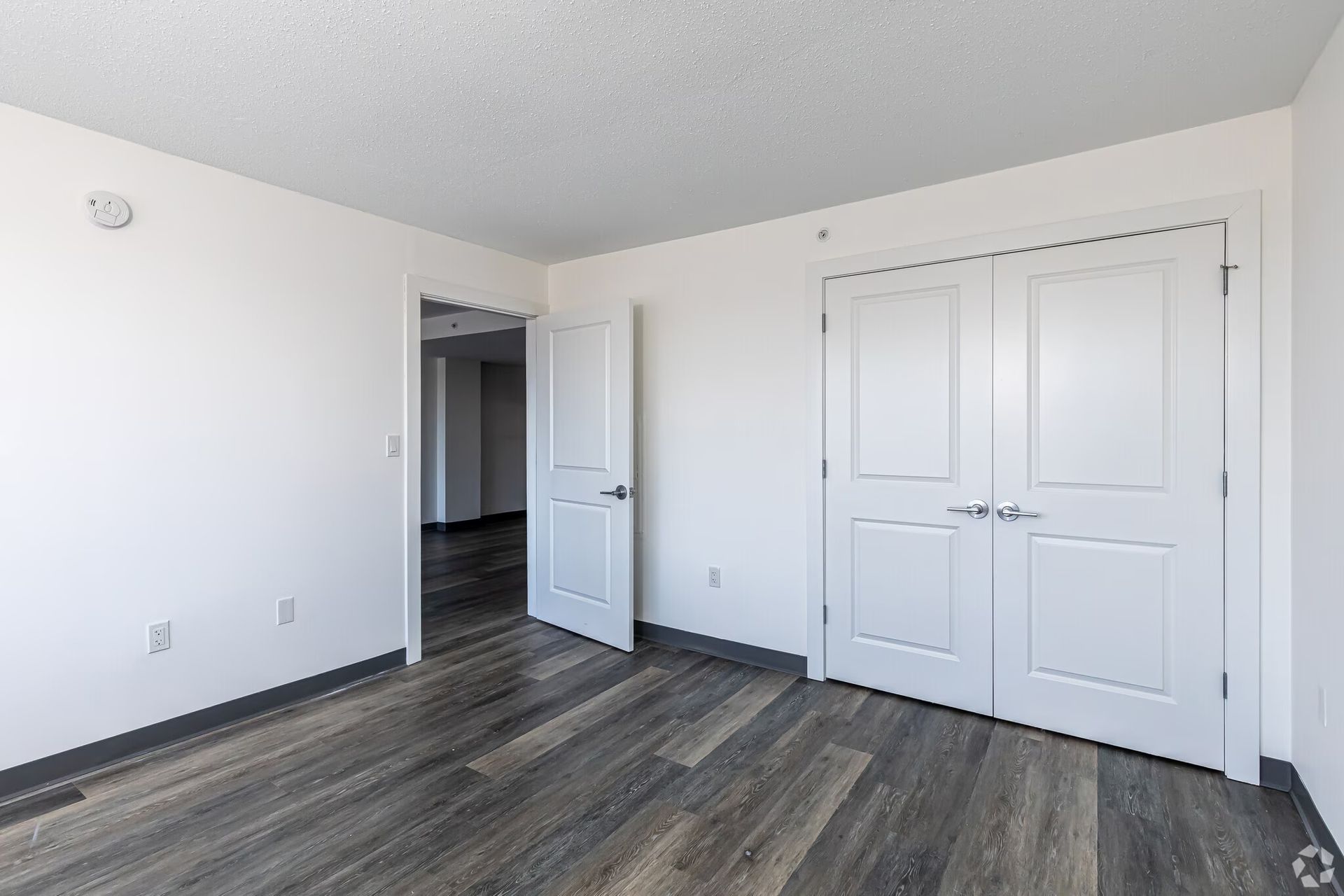 Unfurnished apartment bedroom with closet doors at The Millennium apartments