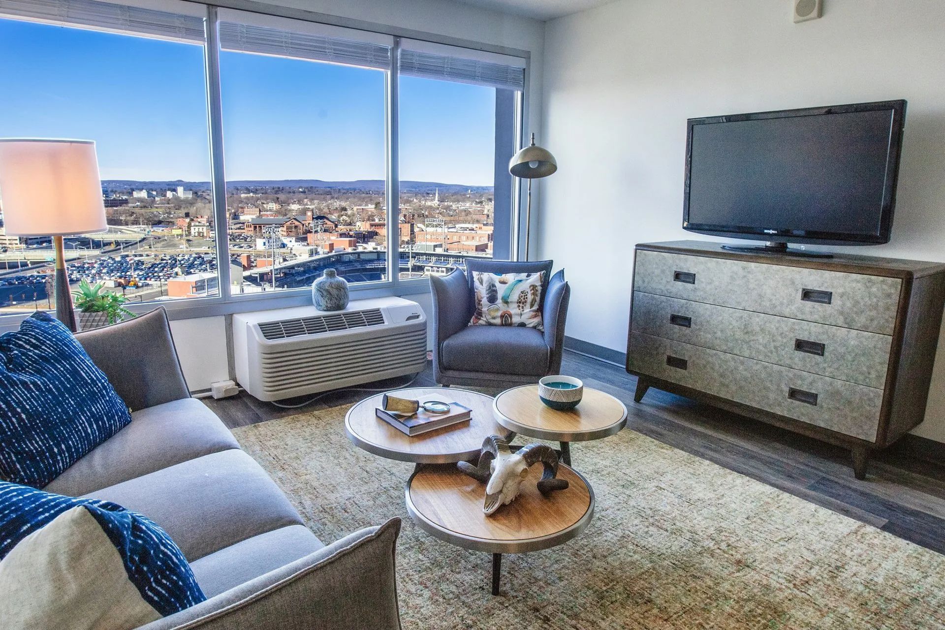 Furnished apartment living room with city views at The Millennium in downtown Hartford