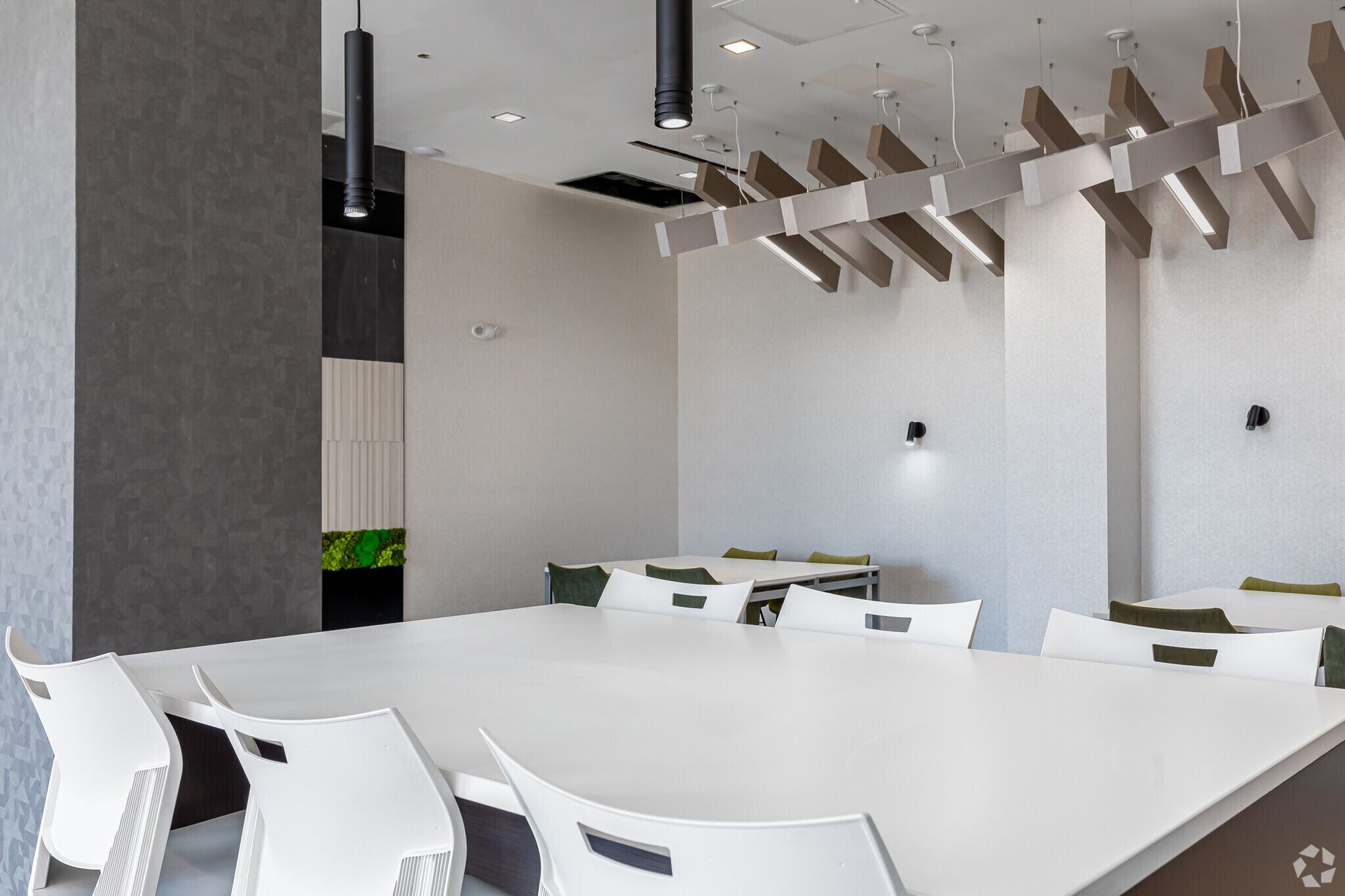 Community dining and meeting space inside The Millennium apartment lobby