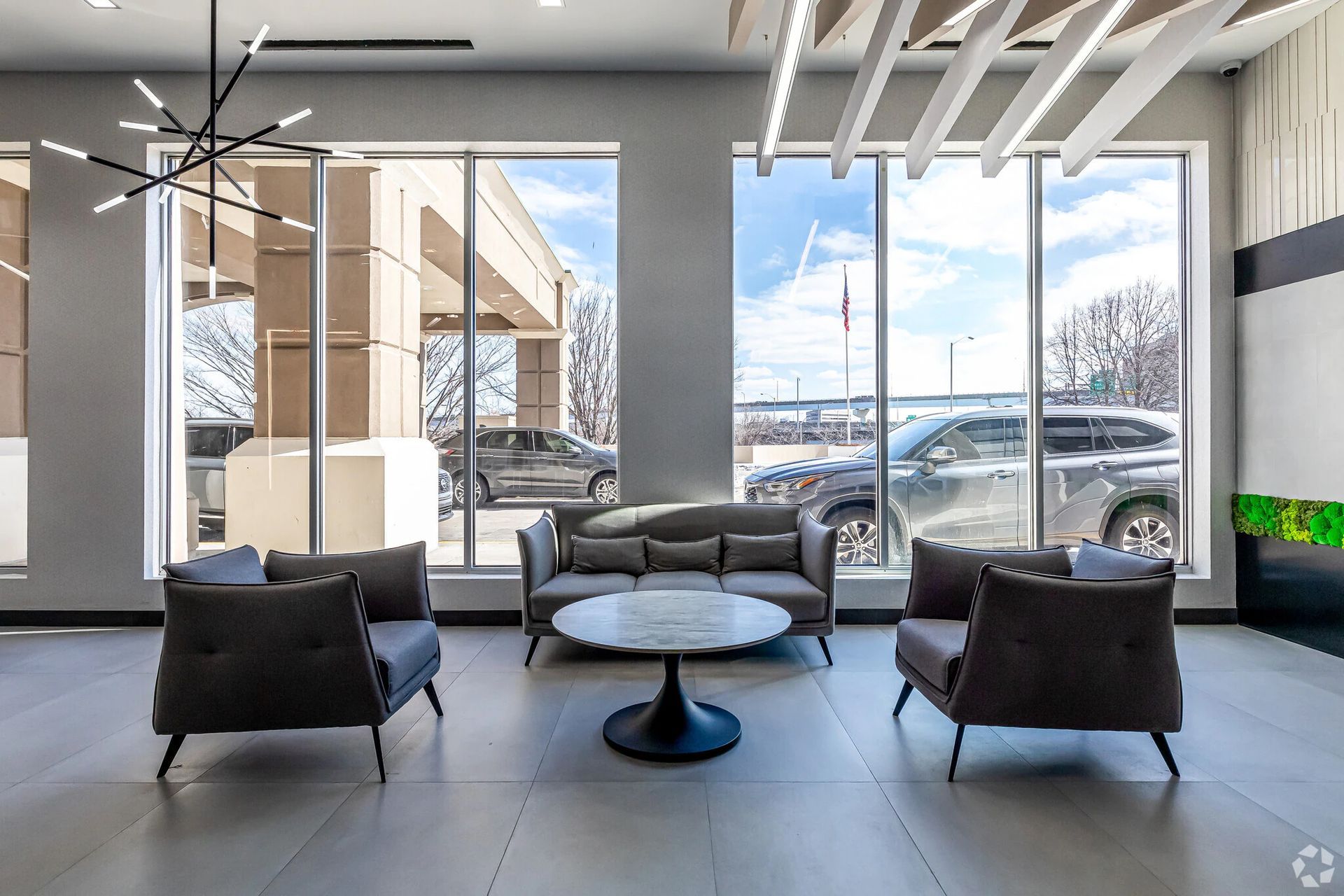 Resident lobby lounge with floor-to-ceiling windows at The Millennium apartments in Hartford