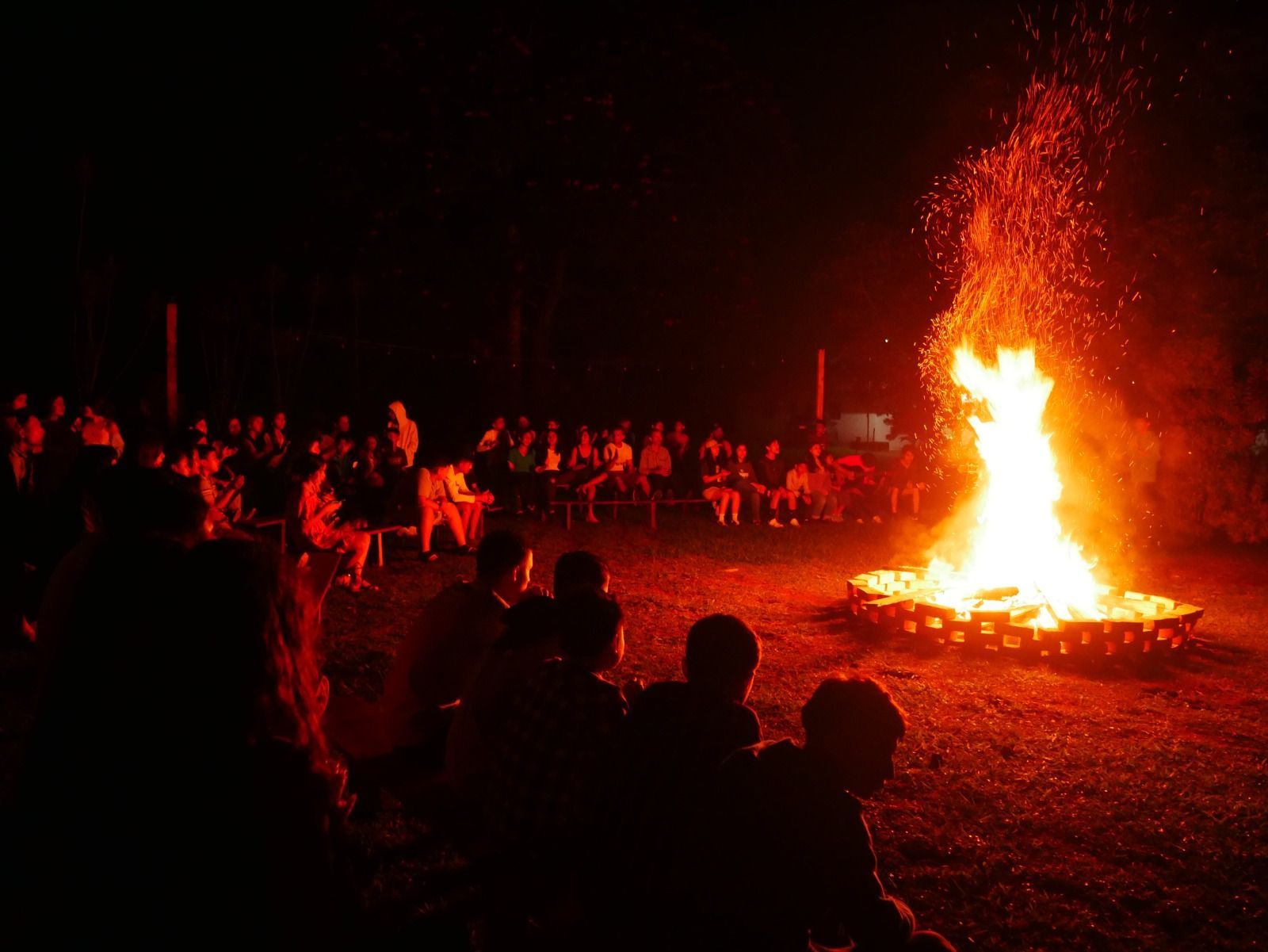 Youth gather around a large bonfire at CEI in Honduras.