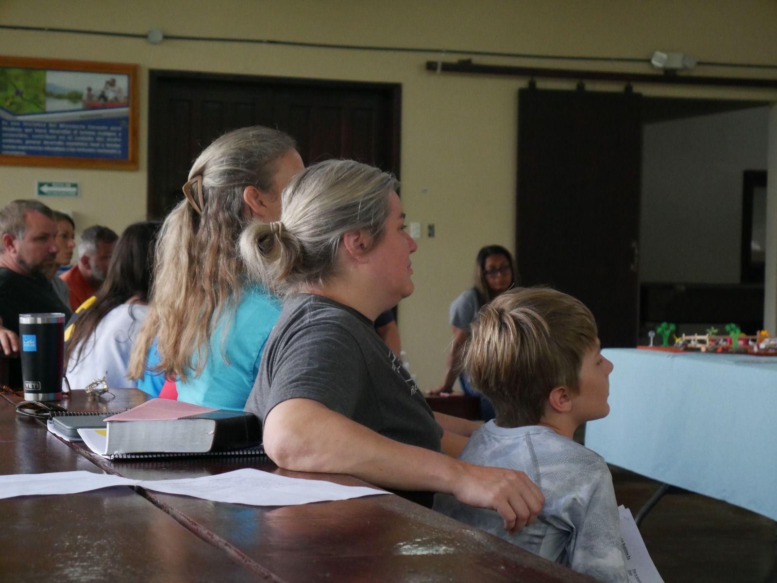 A family listens intently to the Kingdom Families camp speaker.