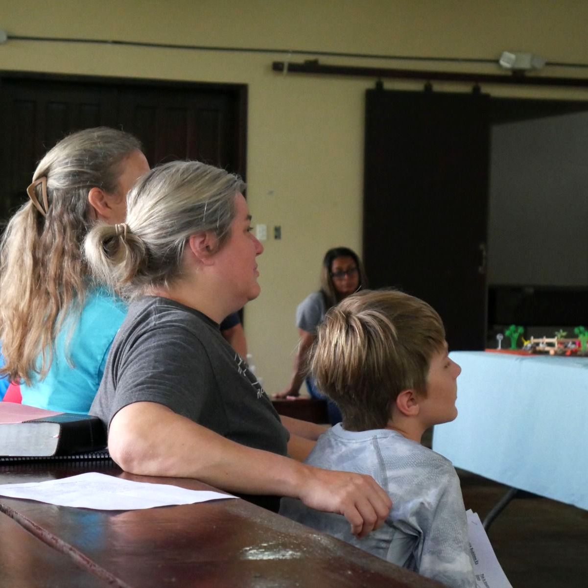 A family listens intently about becoming a partner.