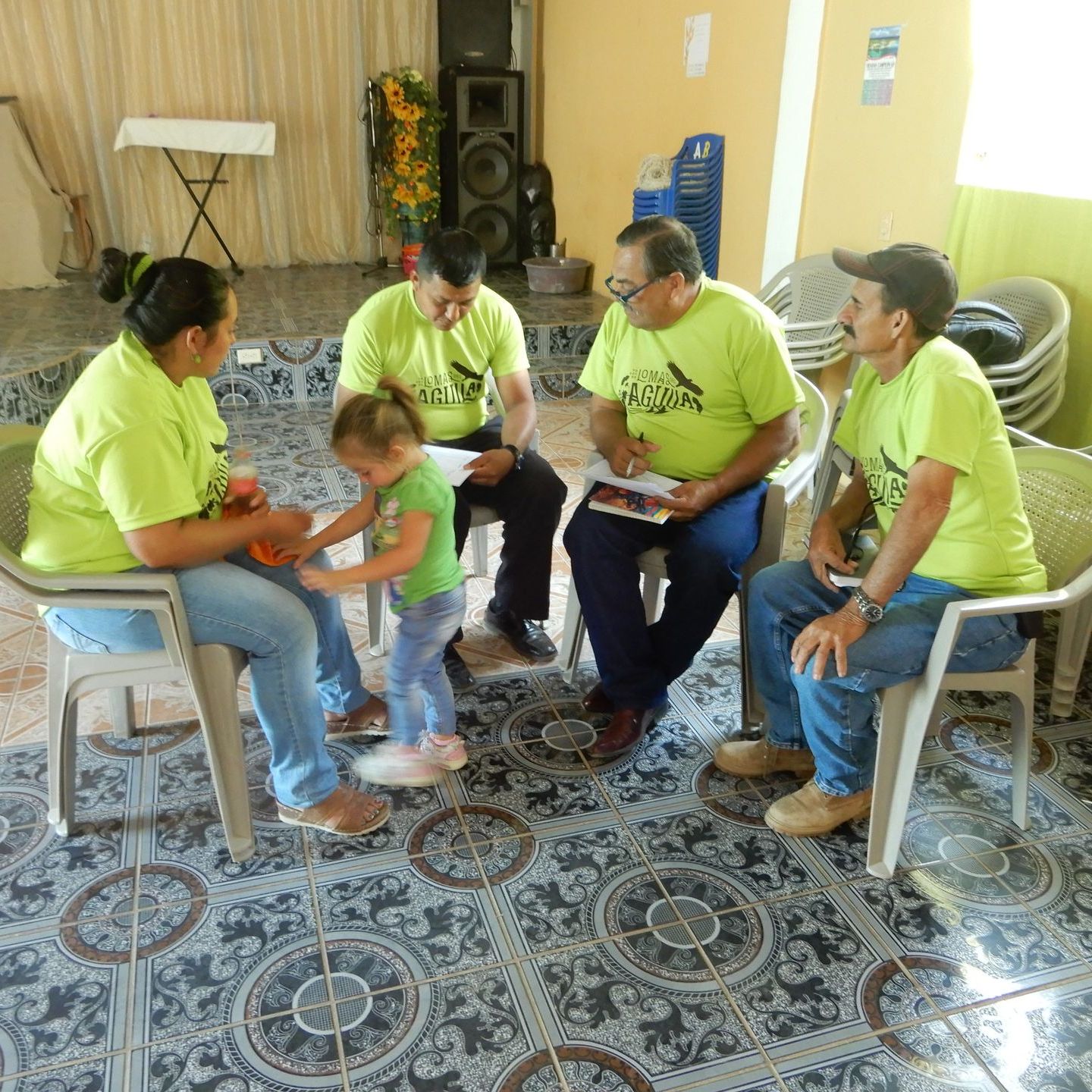A small group gather in a Honduran church for a discussion.