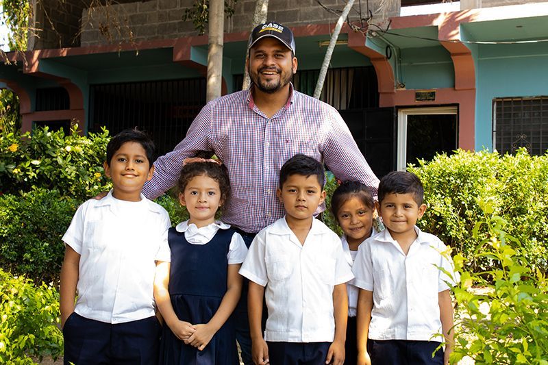 A team member and children pose for the camera in Honduras.