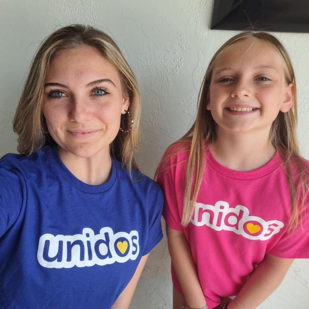 Mother and daughter partners smile for the camera.