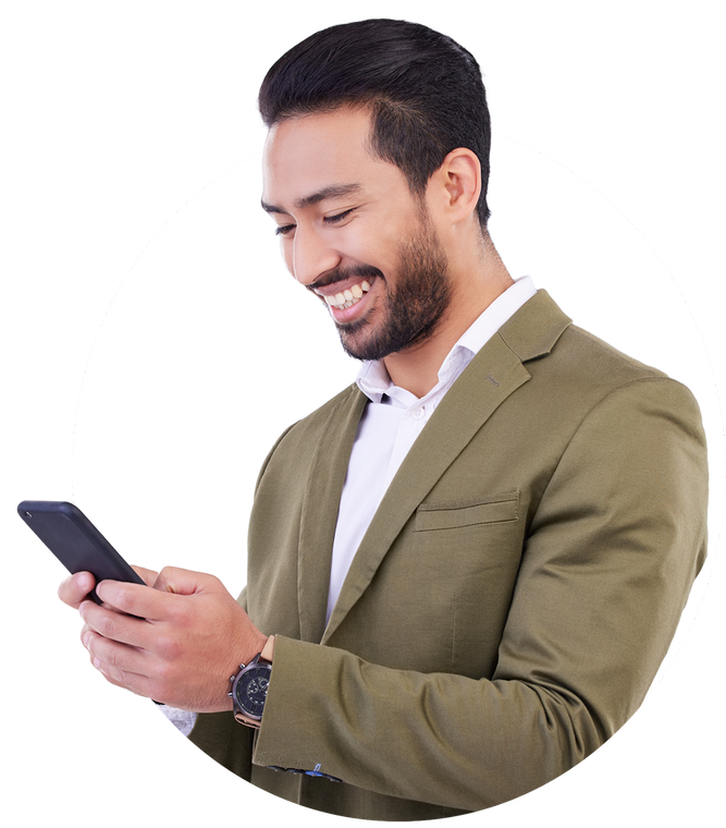Smiling man in a blazer looks at his phone. He has dark hair and a beard.