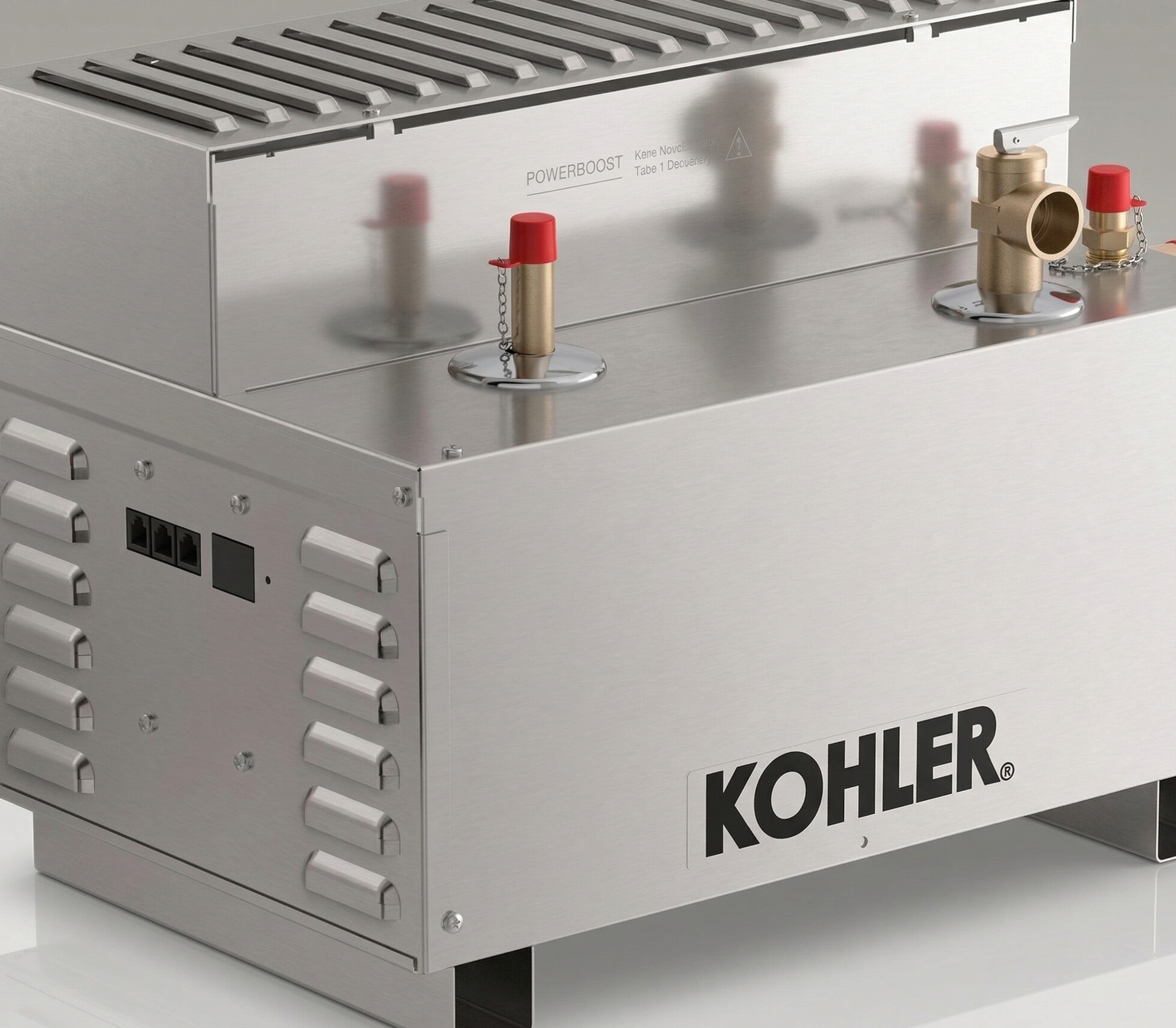 A blue industrial generator sits on a paved surface surrounded by greenery.