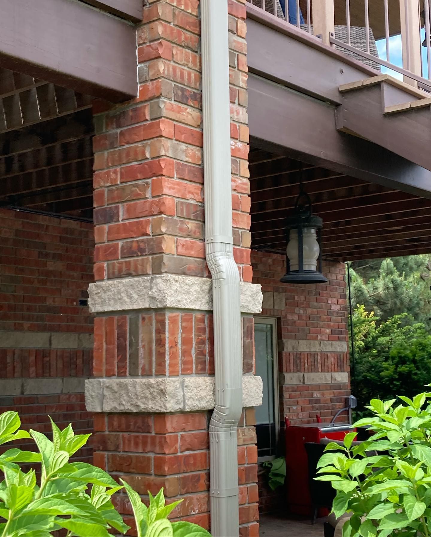 a brick building with a white gutter on the side