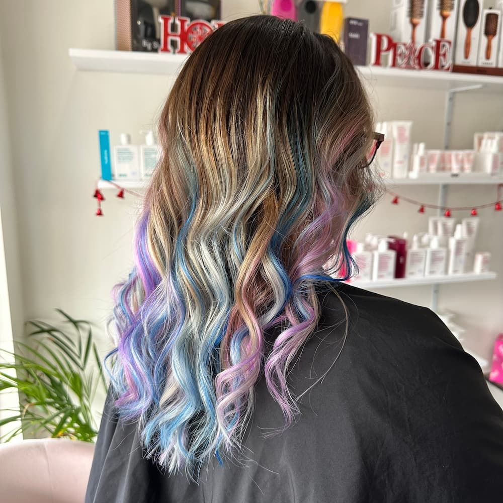 A Woman With Rainbow Hair Is Showing Her New Hair Style — Haelo Hair In Bomaderry, NSW