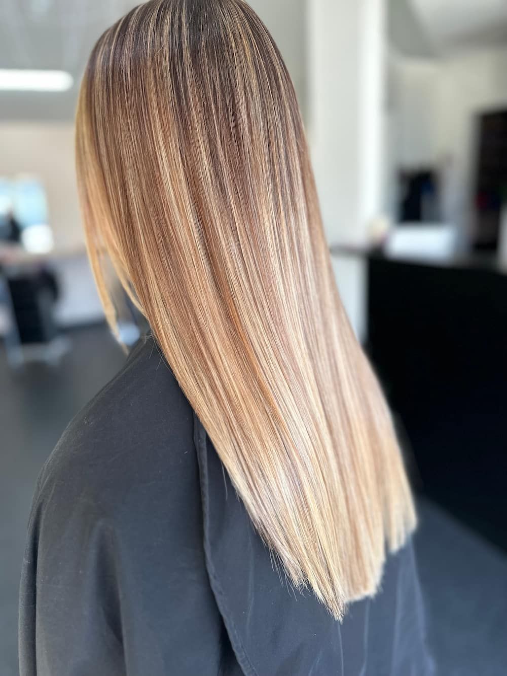 A Woman With Long Blonde Hair Getting Her Hair Blow-dried — Haelo Hair In Bomaderry, NSW