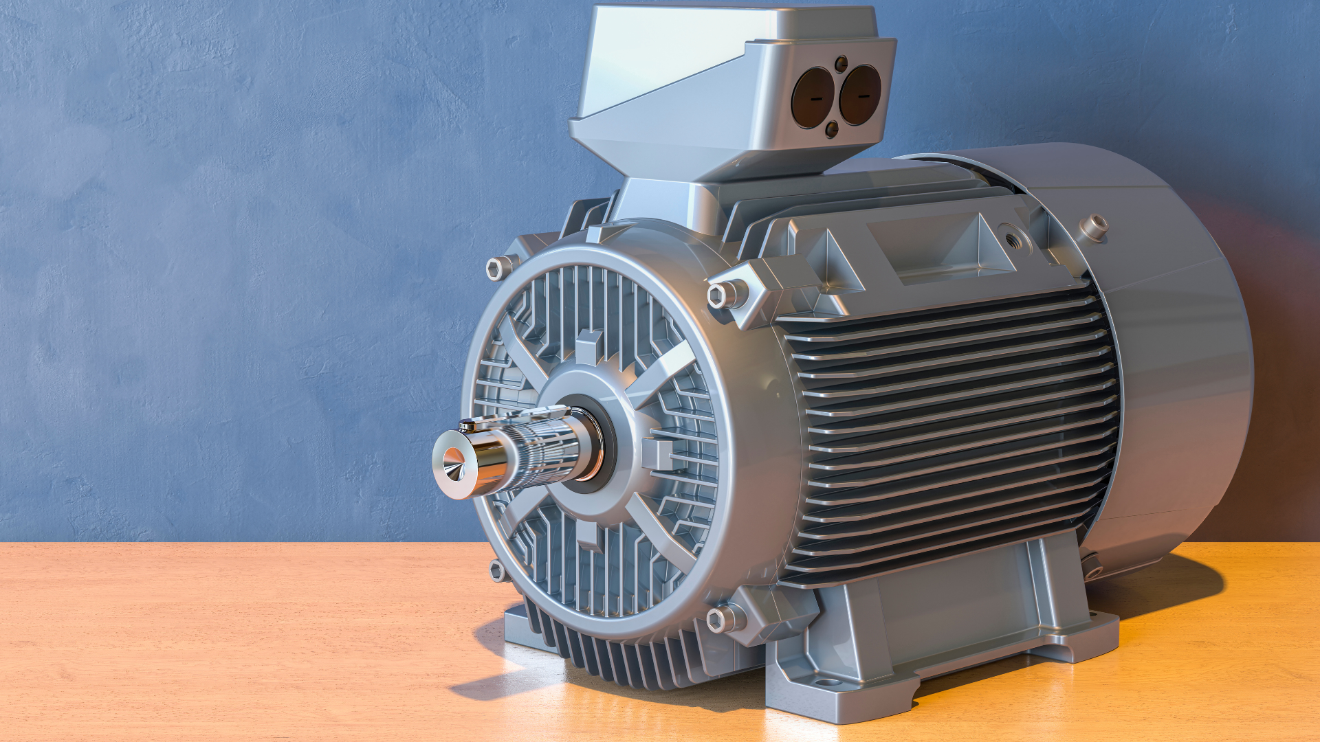 A large electric motor is sitting on a wooden table.