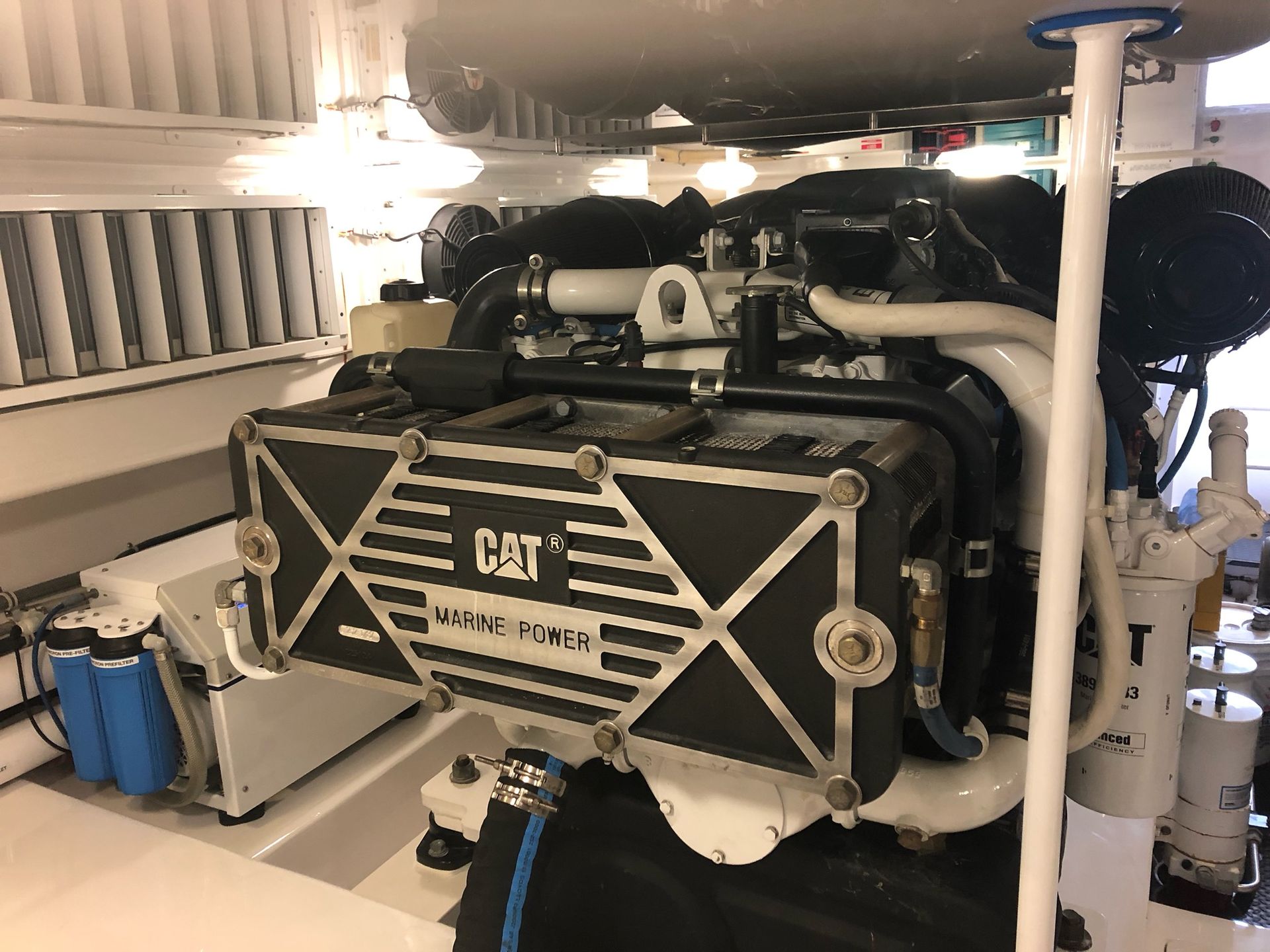 A cat engine is sitting inside of a boat.