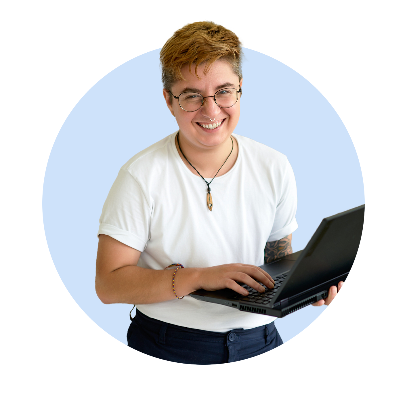 Transgender male holding laptop and smiling towards camera