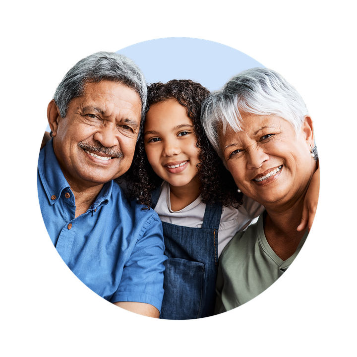 An elderly couple and granddaughter are posing for a picture together