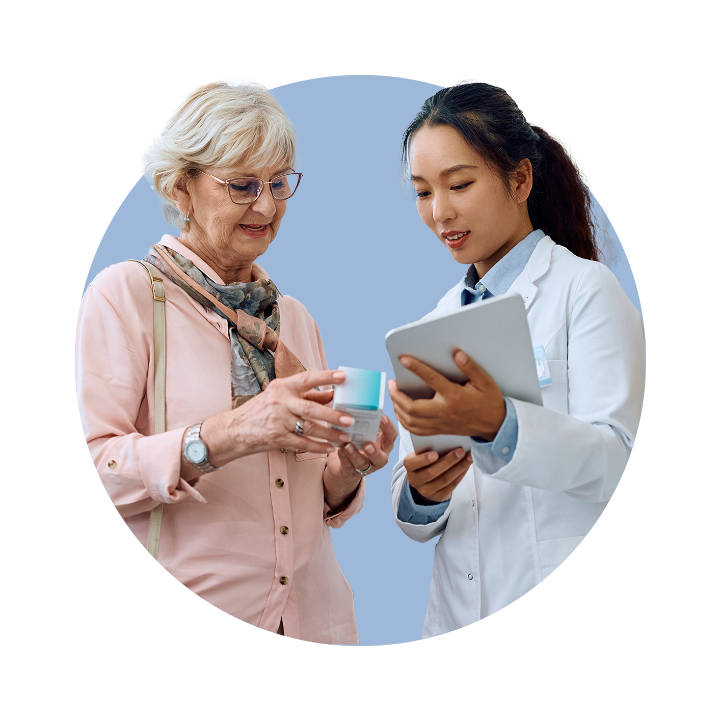 Elderly woman with pharmacist reviewing medication