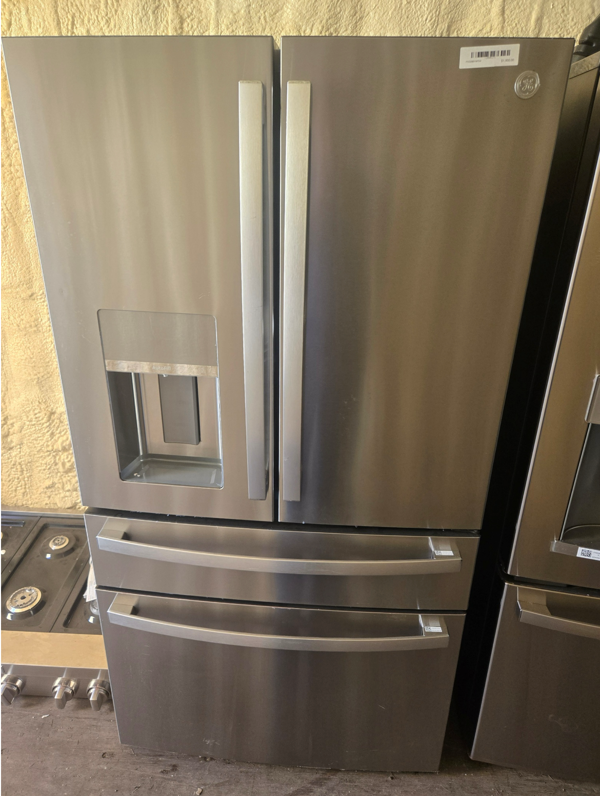 Washing machine with open door, stainless steel drum, blue trim.