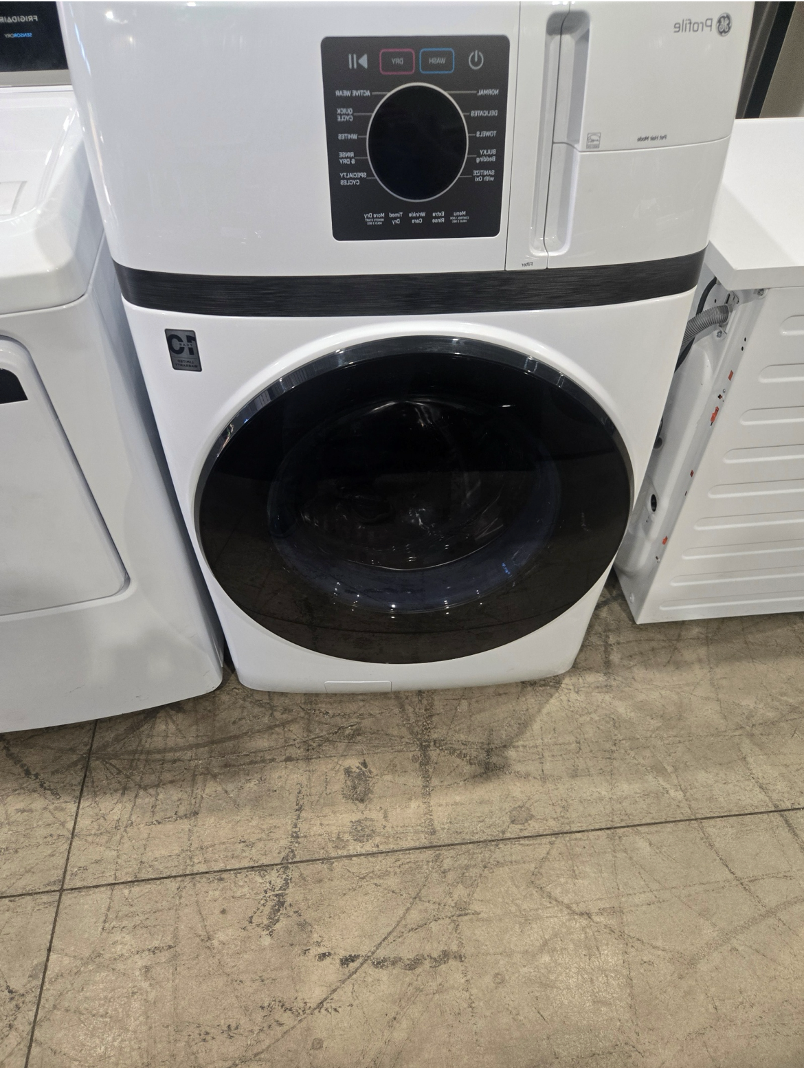 Washing machine with open door, stainless steel drum, blue trim.