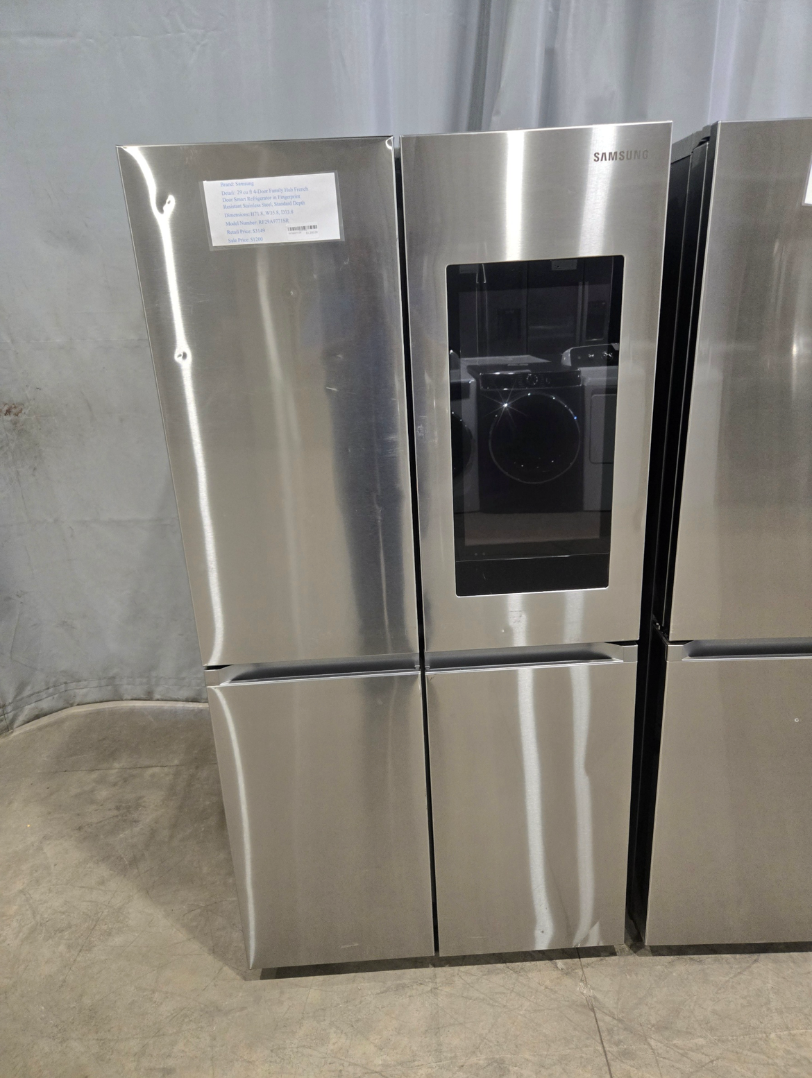 Washing machine with open door, stainless steel drum, blue trim.