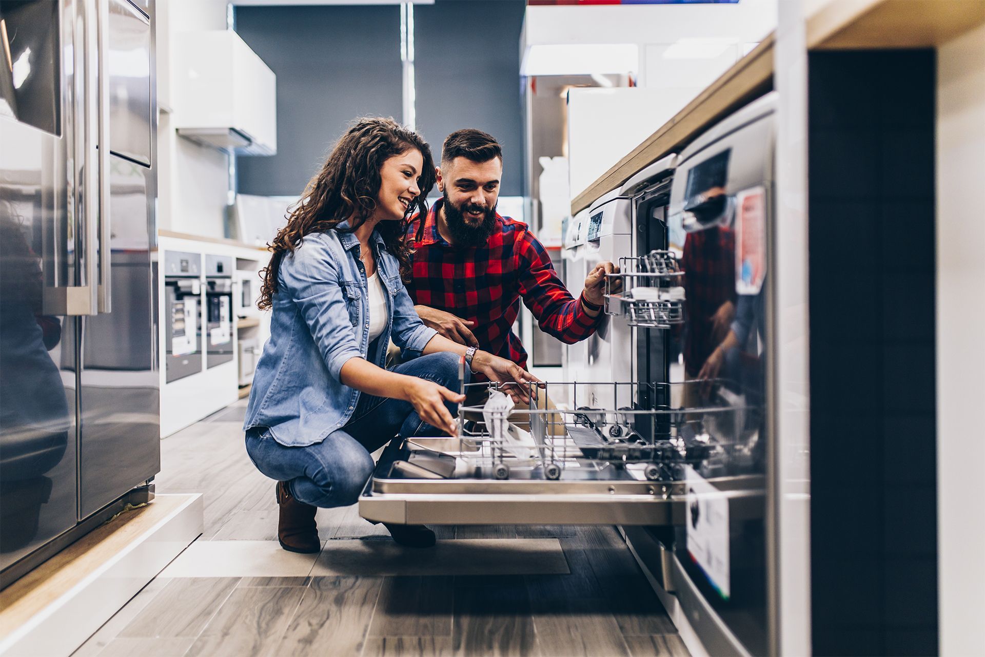 Couple Looking at the Dishwasher in Store