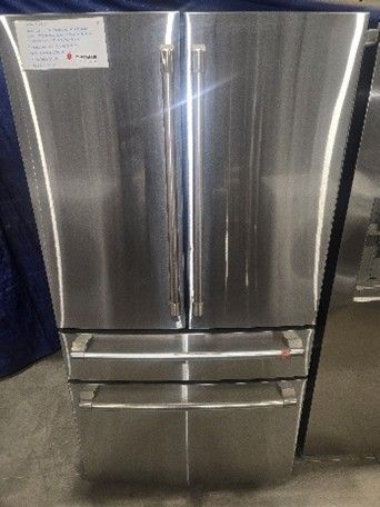 Stainless steel French door refrigerator with bottom freezer drawers.