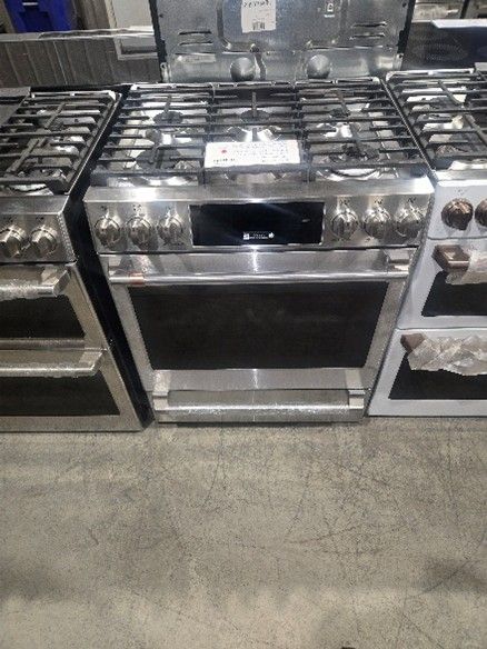 Stainless steel gas range with cooktop and oven.