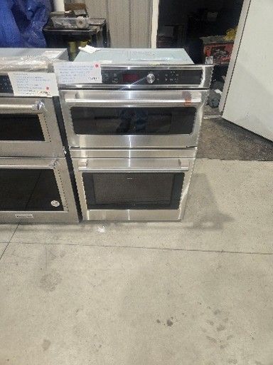 Stainless steel built-in oven with two stacked compartments, control panel at top.