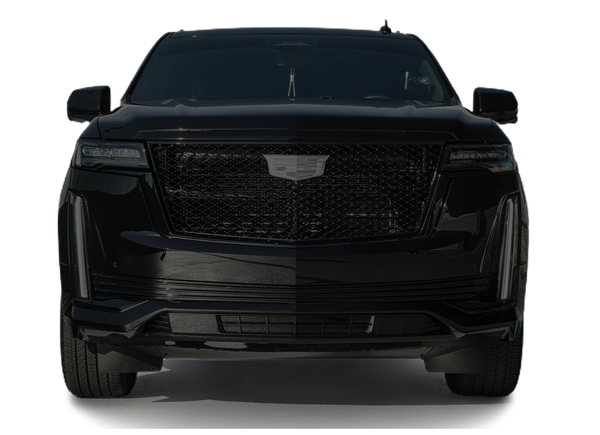The front of a black cadillac escalade is shown on a white background.