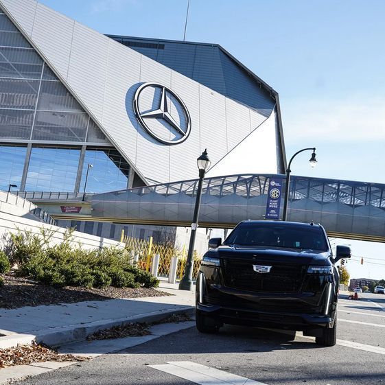 A car is parked in front of a mercedes building
