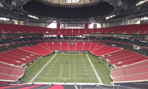 A white car icon with a shadow on a white background.