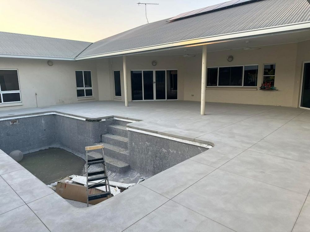 Grey Concrete Pool Under Construction With a House in the Background — Mobcon Construction in Berry Springs, NT