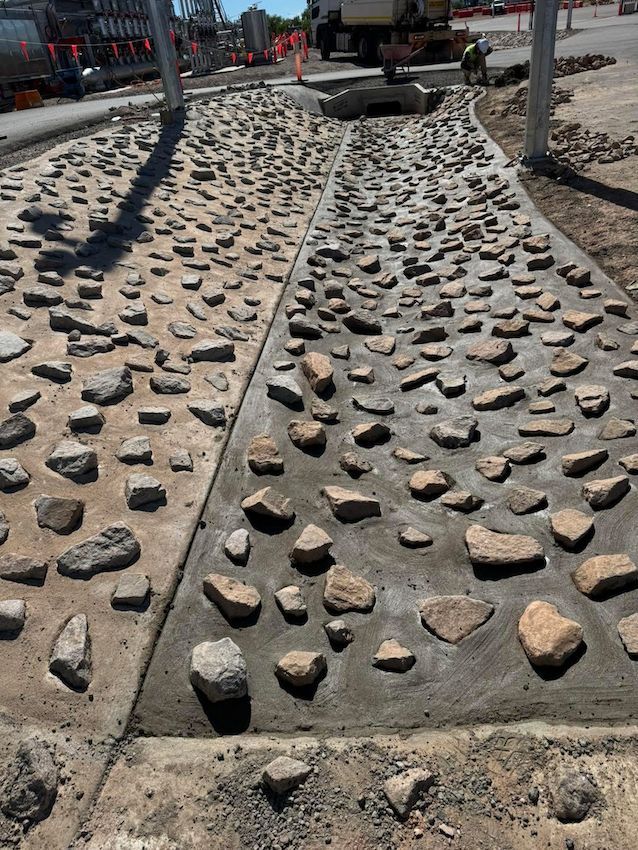 Concrete Path With Embedded Rocks, Possibly Part of a Park or Walkway — Mobcon Construction in Humpty Doo, NT