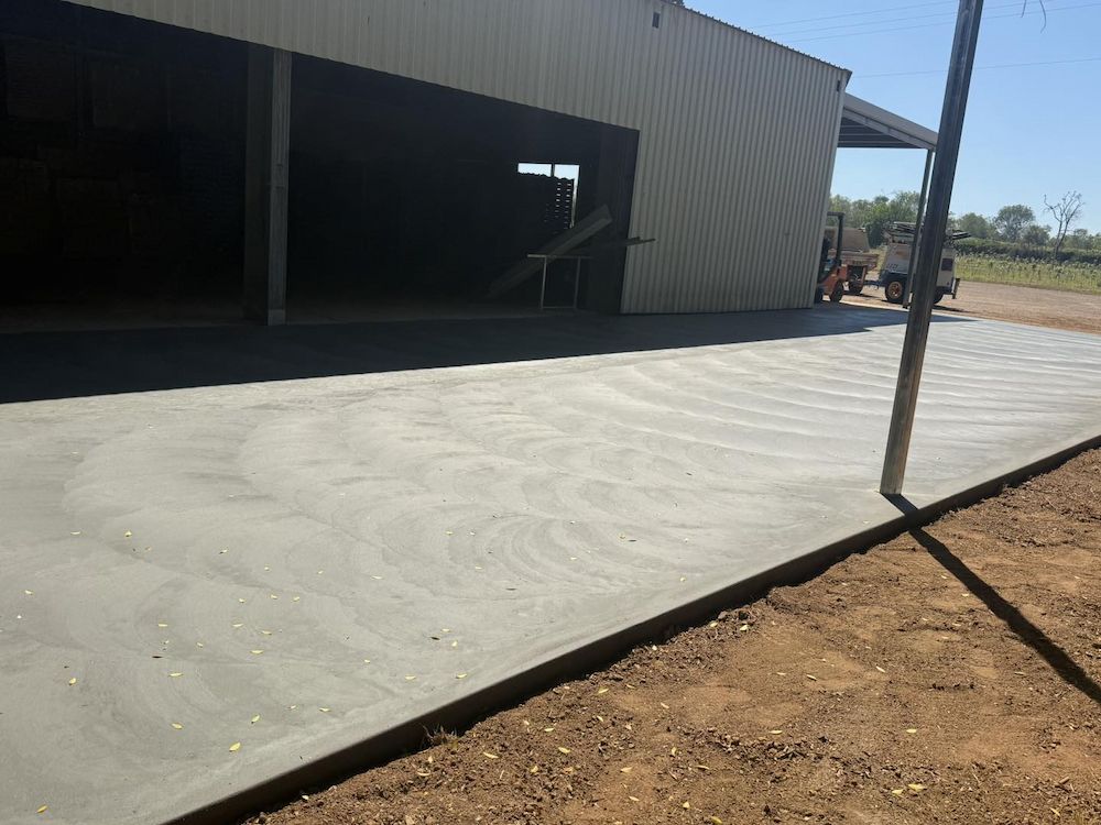 New Concrete Slab in Front of a Corrugated Metal Building — Mobcon Construction in Humpty Doo, NT