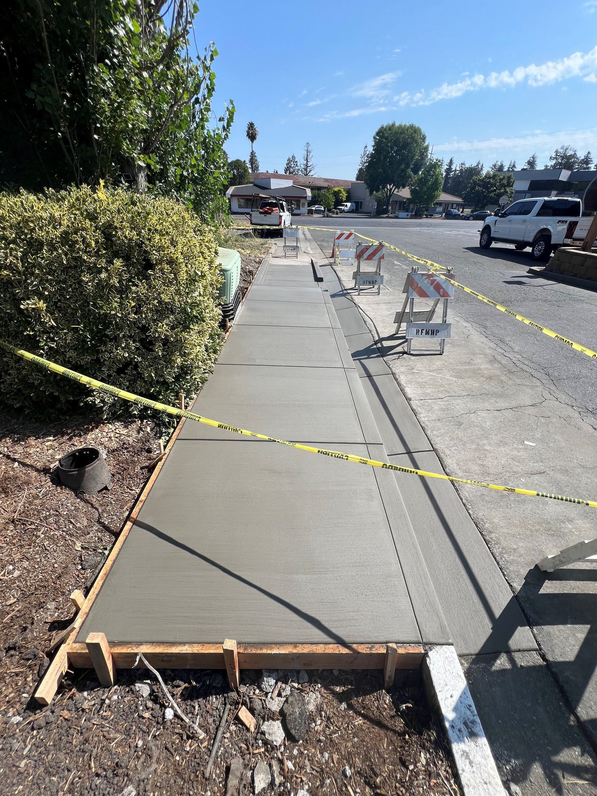 An empty sidewalk in front of a large building.