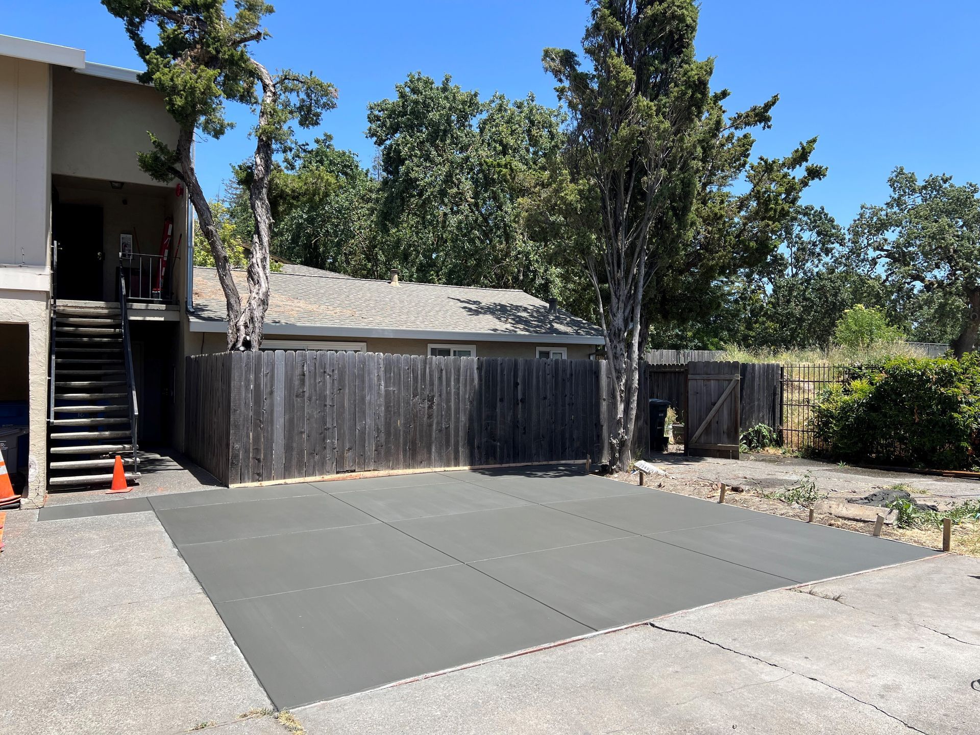 A concrete sidewalk is being built on the side of the road.