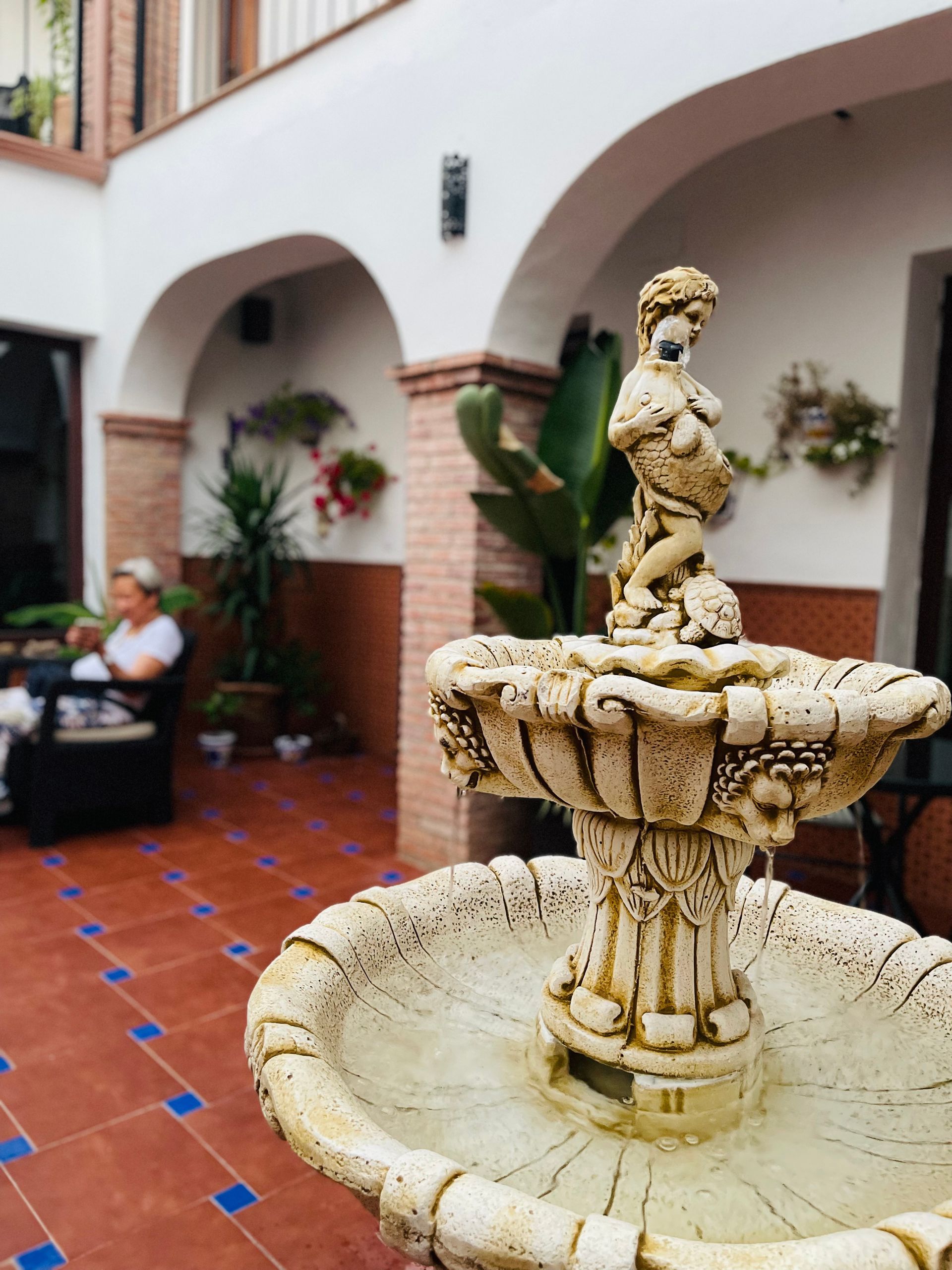 A fountain with a statue of a woman on top of it