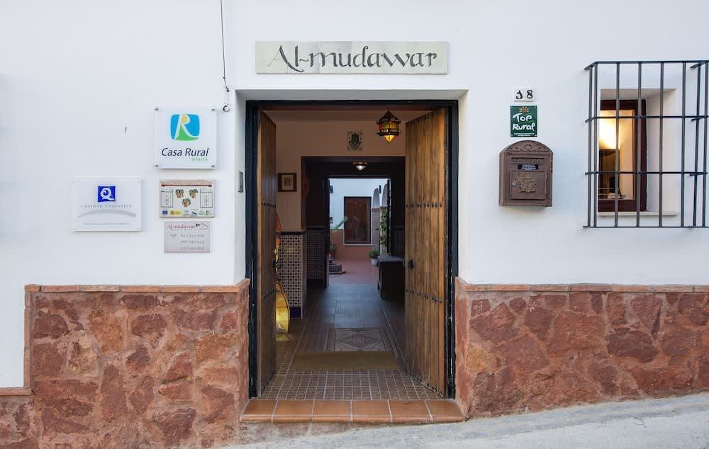 A white building with a mailbox on the side of it