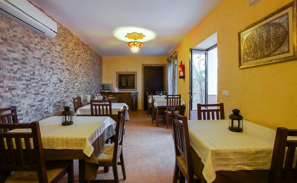 A dining room with tables and chairs and a lantern on the table