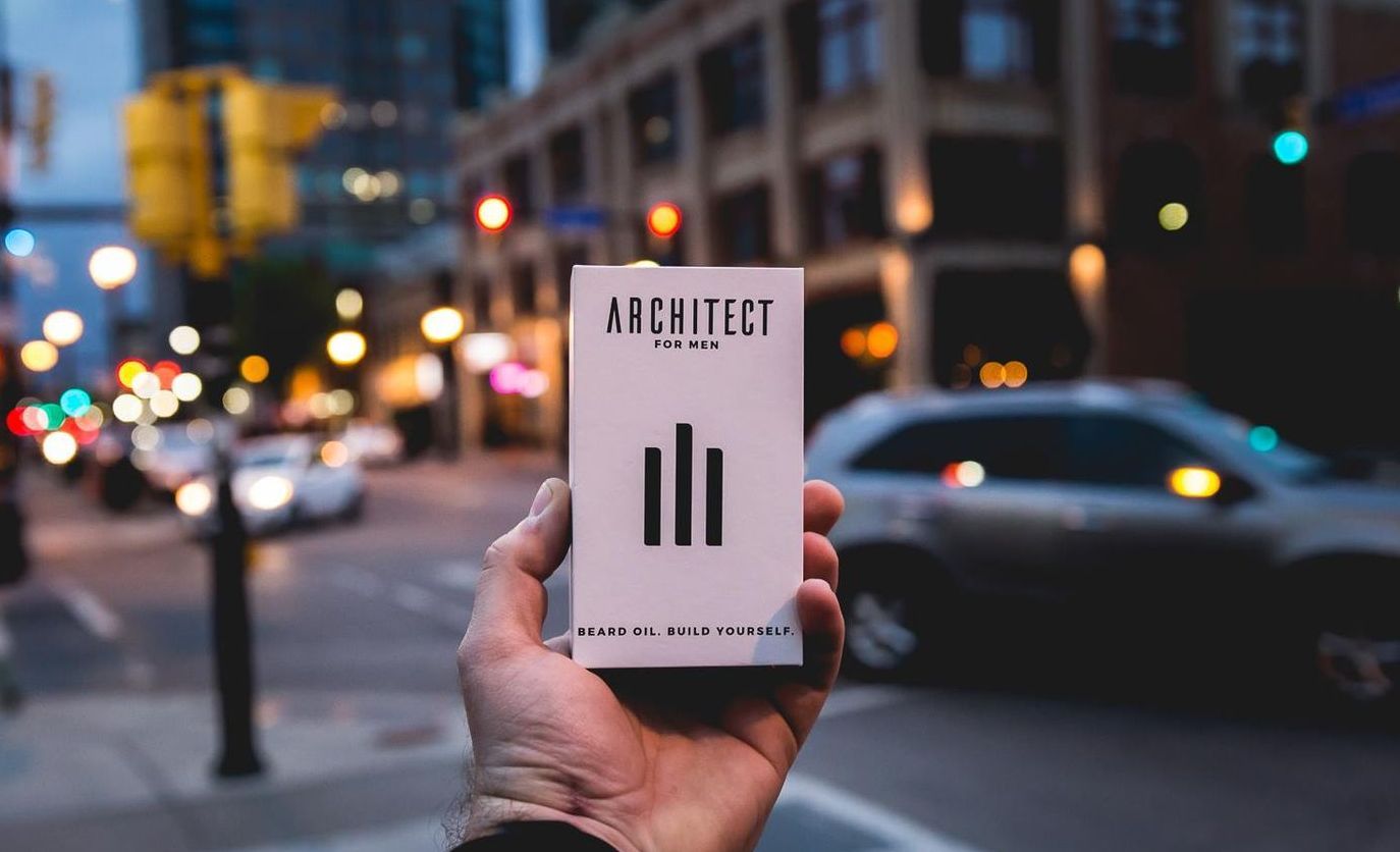 A person is holding a box that says architect on it