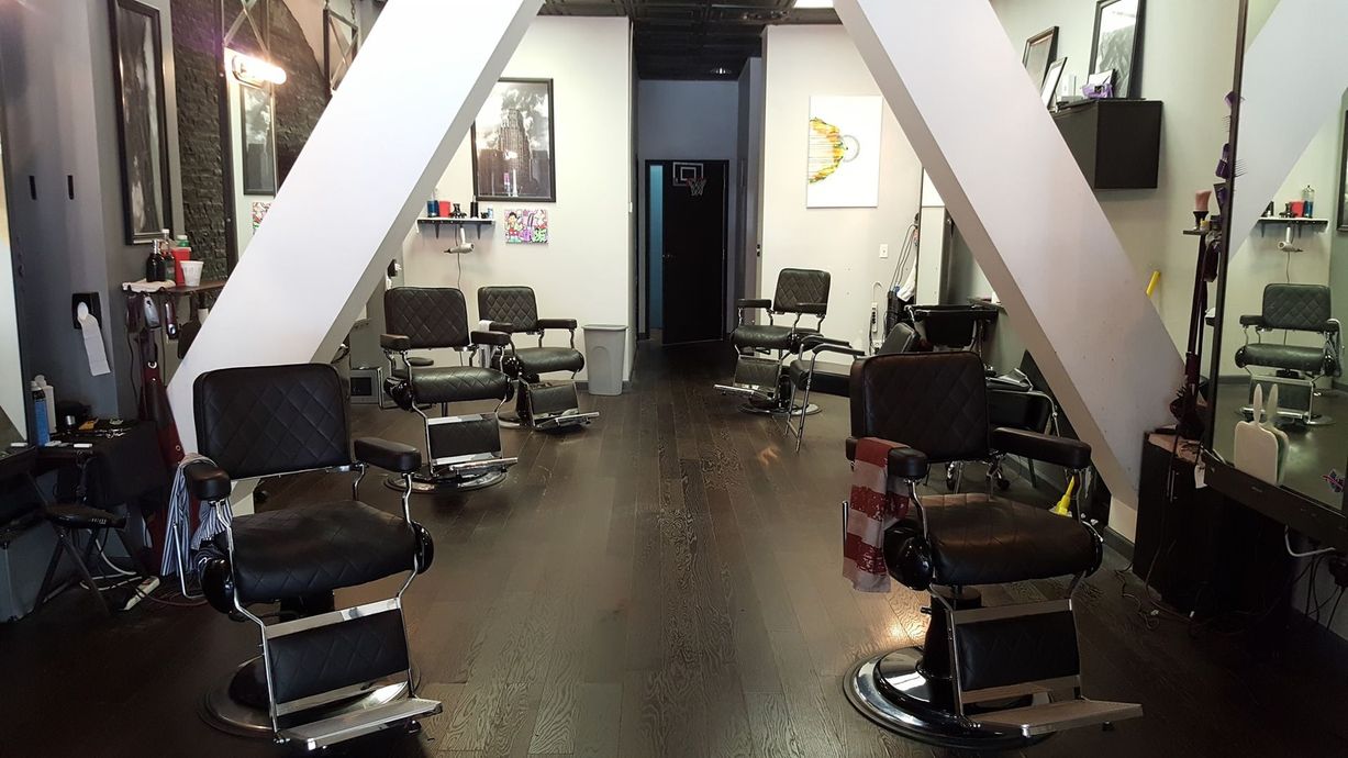 A barber shop with a lot of chairs and mirrors