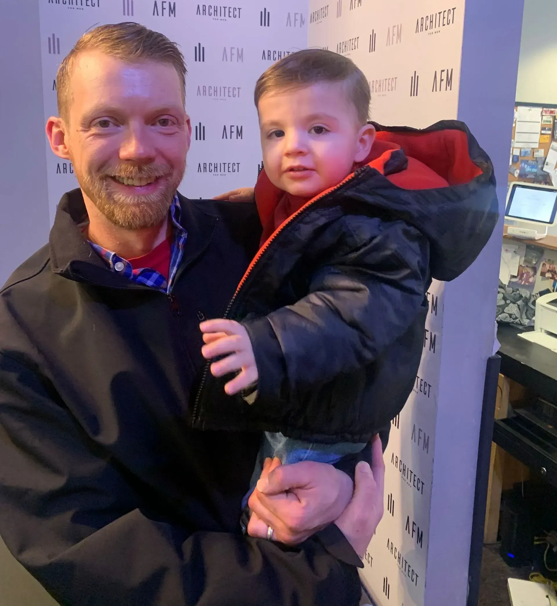 A man is holding a small child in his arms